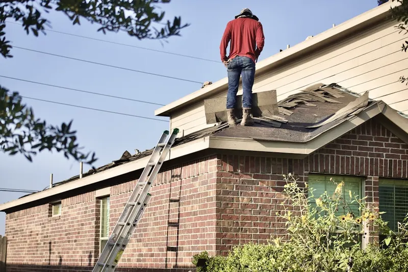 Professional roofer working on a residential roof in Trilogy